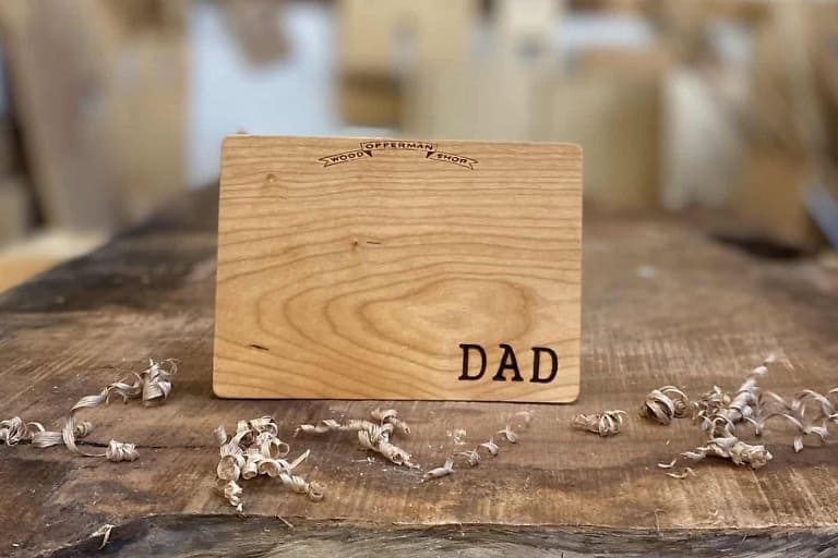 Engraved wooden Father’s Day card featuring “DAD” for a personalized gift.