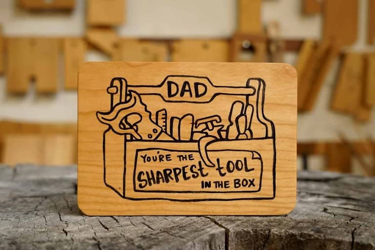 Handcrafted wooden Father's Day card with engraved dad joke message.